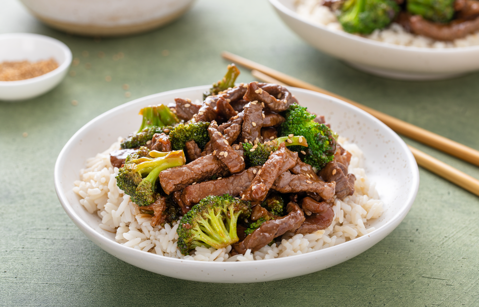 Broccoli and beef stir fry on top of fluffy white jasmine rice