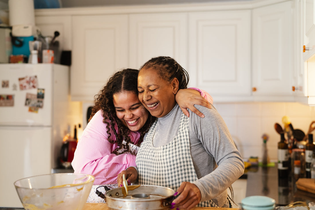  A mother and daughter are baking together in the kitchen, preparing a healthy, eating-friendly recipe with fresh ingredients