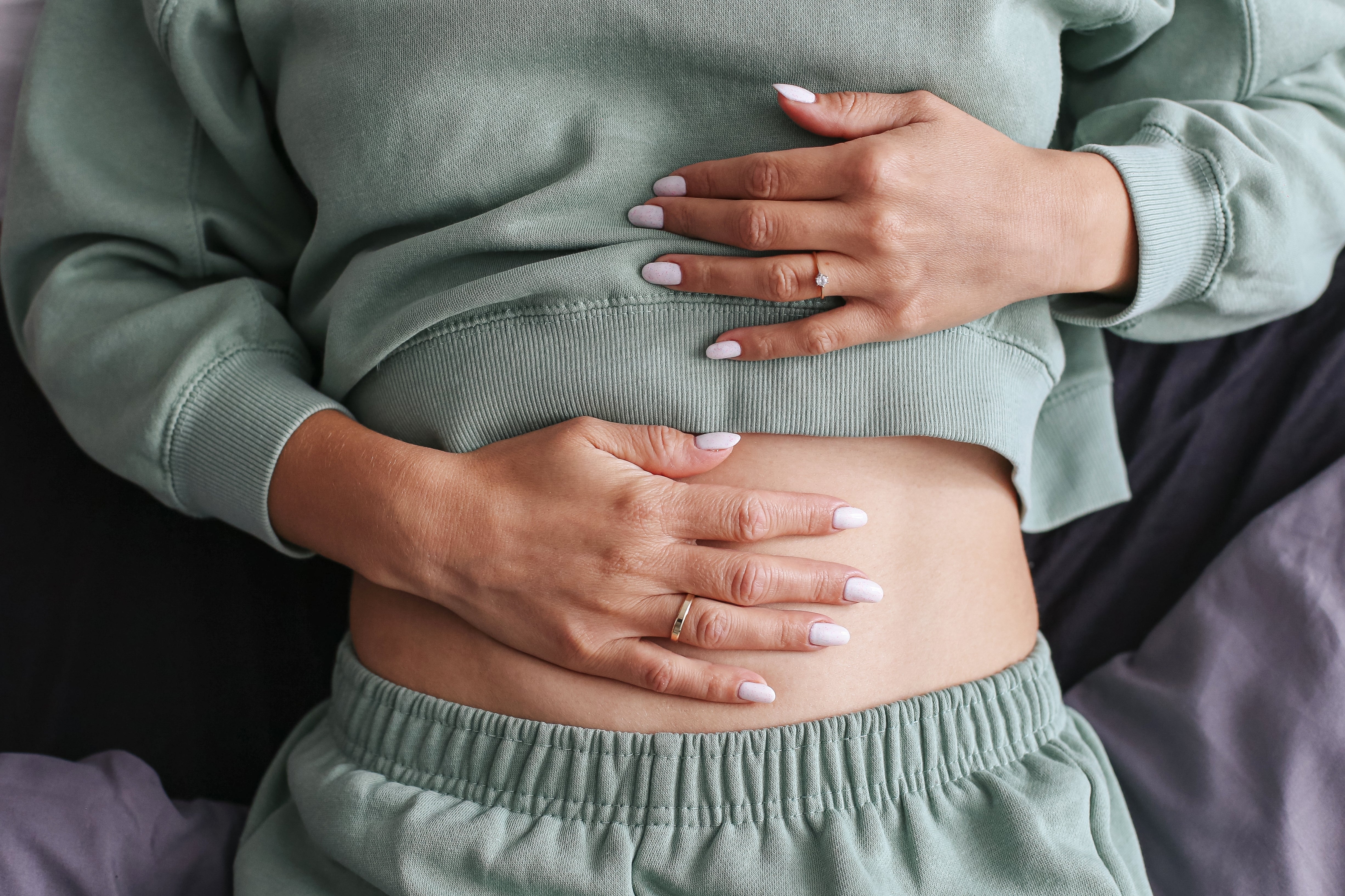 Woman holding her stomach.